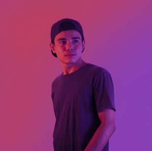 Portrait of a young man against red background