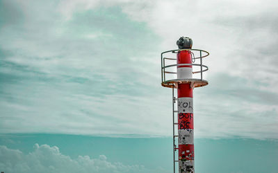 Low angle view of red flag against sky