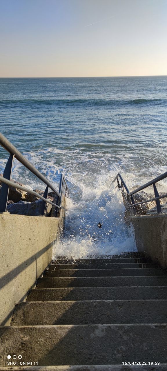 water, sea, sky, horizon, shore, horizon over water, ocean, nature, coast, transportation, beach, vehicle, land, nautical vessel, scenics - nature, no people, wave, beauty in nature, boat, tranquility, motion, day, mode of transportation, clear sky, outdoors, tranquil scene, sunlight, railing, travel, pier, wood