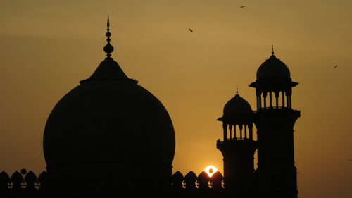 Silhouette of building against sky during sunset