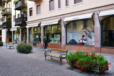 View of people on footpath by building