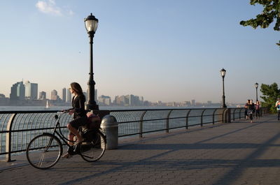 Bicycle on street against sky in city