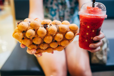 Close-up of hand holding strawberries