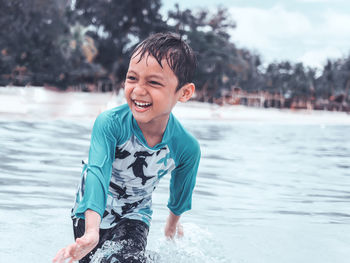 Portrait of smiling boy in water