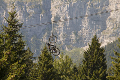 Bicycle hanging from cable