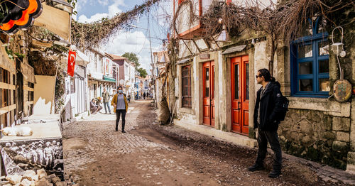 People walking on street amidst buildings in city