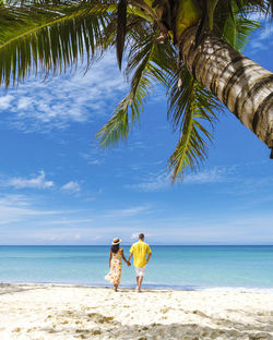 Tropical island koh kood or koh kut thailand, couple walking on a white beach