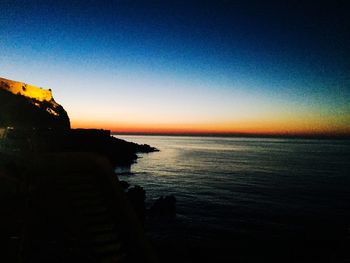 Scenic view of sea against clear sky during sunset