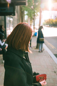 Close-up of woman standing on bench