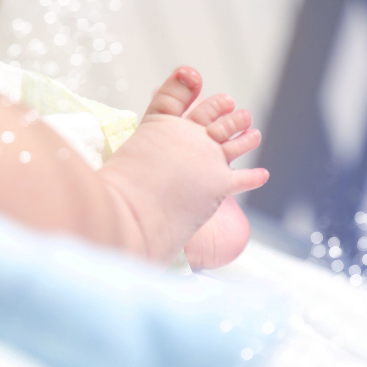 person, part of, close-up, focus on foreground, human finger, cropped, selective focus, lifestyles, holding, childhood, fragility, unknown gender, baby, leisure activity, barefoot, indoors