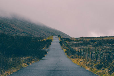 Road amidst landscape against sky