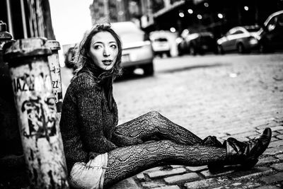 Woman standing on city street