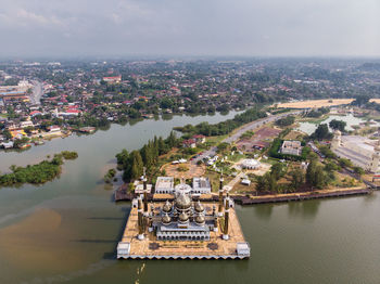 High angle view of crystal mosque by river 