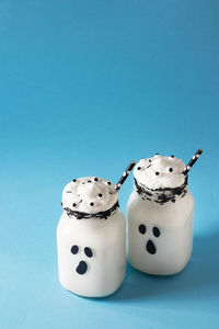 High angle view of cupcakes on table against blue background
