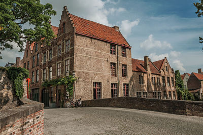 Bridge and brick buildings on the canal edge in bruges. a town full of canals in belgium.