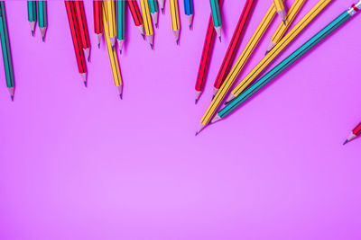 High angle view of multi colored pencils against blue background