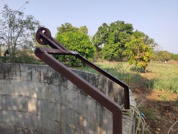 Rusty metal railing against clear sky