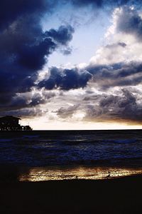 Scenic view of sea against cloudy sky
