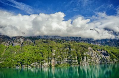 Scenic view of mountains against cloudy sky