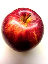 Close-up of red apple over white background