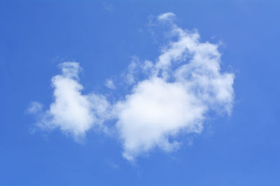 Low angle view of heart shape against blue sky