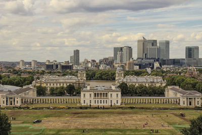 View of cityscape against cloudy sky