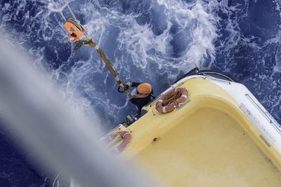 High angle view of people on boat in sea