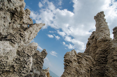 Low angle view of rock formation against sky