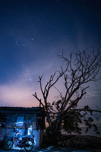 Bicycles against sky at night