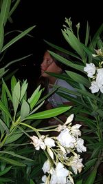 Close-up of woman by flowering plant