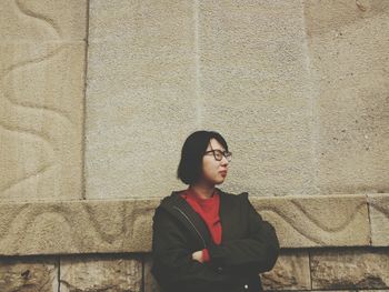 Woman standing against wall