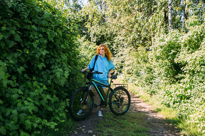 A young woman uses a modern electric bicycle for sports and outdoor recreation