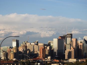 City skyline against cloudy sky