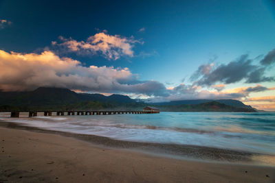 Scenic view of beach against sky during sunset