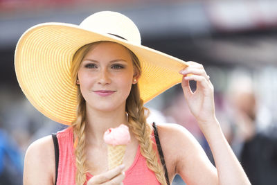 Woman looking away while having ice cream