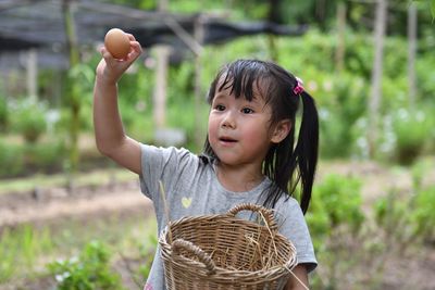 Portrait of girl holding wicker basket
