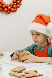High angle view of boy with christmas decorations on table