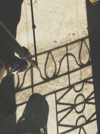 Low section of man holding shadow