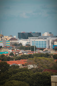 High angle view of buildings in city against sky