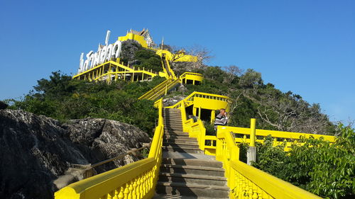 View of yellow bridge against clear blue sky