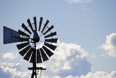 Low angle view of traditional windmill against sky