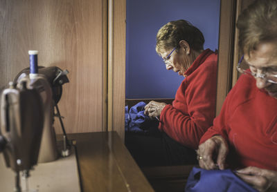 Woman sewing textile in home