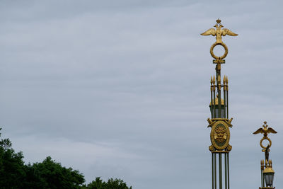 Low angle view of communications tower against sky