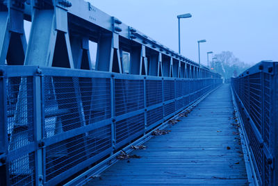 View of suspension bridge against blue sky