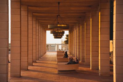 People sitting in corridor of building