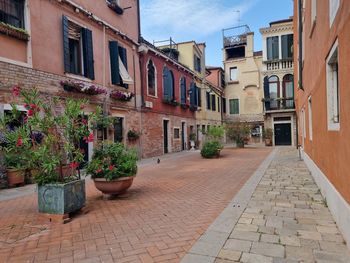 Footpath amidst buildings in city