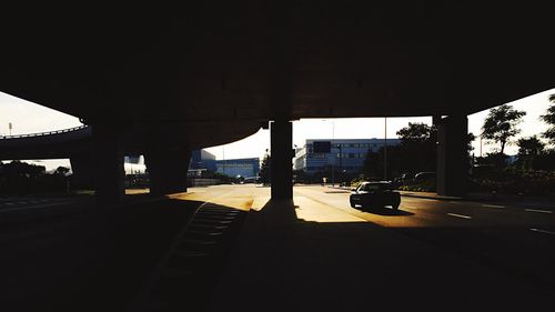 Cars on road at sunset