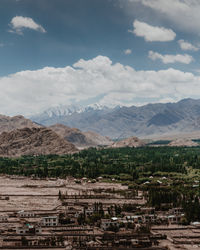 Scenic view of mountains against cloudy sky