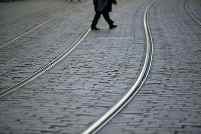 Low section of person walking on railroad track