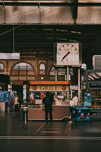 People waiting at railroad station in city